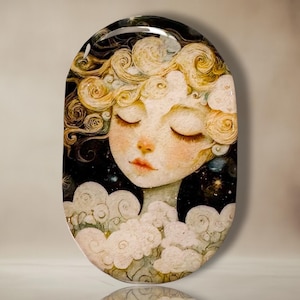 May include: An oval-shaped decorative tray featuring a serene illustration of a woman with closed eyes and curly blonde hair. The woman is surrounded by clouds and a starry night sky. The color palette includes soft pastels and dark blues.