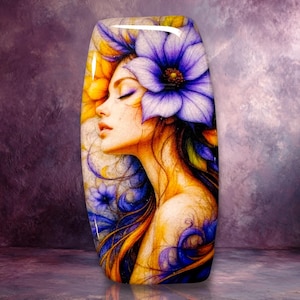 May include: A rectangular glass plaque featuring a profile illustration of a person with closed eyes, adorned with a large purple flower in their hair. The artwork incorporates vibrant yellow, blue, and purple hues with swirling patterns.