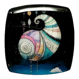 May include: A square, decorative glass piece with a black background featuring a colorful, abstract design. The design includes a spiral shape with pastel colors, and hanging orbs. A white cloud is at the bottom.