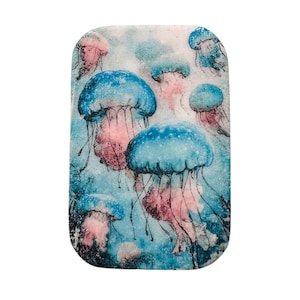 May include: Rectangular art piece featuring a watercolor illustration of several jellyfish. The jellyfish have blue, pink, and white coloration, with long, flowing tentacles. The background is a mix of blue and white.