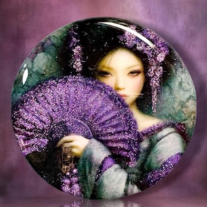 May include: A circular glass cabochon featuring a portrait of a person with dark hair adorned with purple glitter accents. The person holds a large, vibrant purple glitter folding fan in front of their face, wearing a matching purple garment.