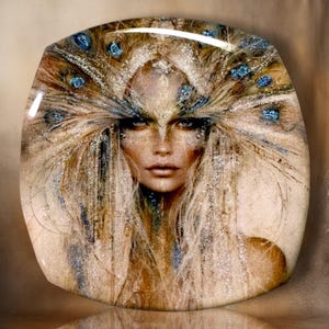 May include: A square decorative plate featuring a high-gloss finish and a central portrait of a person with long, flowing blonde hair adorned with blue peacock feather accents. The image incorporates shimmering silver glitter details throughout.
