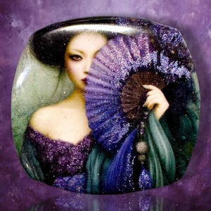 May include: A square-shaped decorative plaque featuring a portrait of a person with dark hair, wearing a purple garment, and holding a large, glittery purple folding fan that partially obscures their face against a dark, textured background.