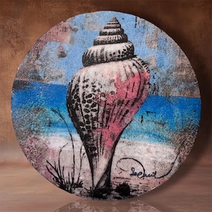 May include: A circular wall art piece featuring a detailed illustration of a spiral seashell in shades of pink, black, and white. The background depicts a blue ocean and sandy beach scene with textured brushstrokes and a signature in the corner.
