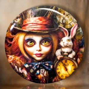 May include: A circular pinback button featuring a colorful illustration of a character with large yellow eyes wearing a red top hat, a blue patterned bowtie, and a white rabbit holding a gold pocket watch with Roman numerals on the clock face.