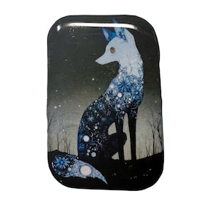 May include: A rectangular, glossy, decorative item featuring a seated fox illustration. The fox is white and blue, with intricate floral patterns. The background is dark with a starry sky and silhouettes of trees.