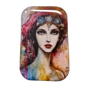 May include: Rectangular art piece featuring a watercolor portrait of a woman. The woman has long, wavy, reddish-purple hair, blue eyes, and red lips. She wears a blue floral crown. The background has a watercolor effect with hues of blue, yellow, and pink.