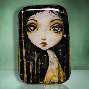 May include: A rectangular decorative tray featuring a stylized illustration of a girl with large eyes and long black hair. The artwork includes stars and a yellow and black color scheme, creating a whimsical and artistic design.