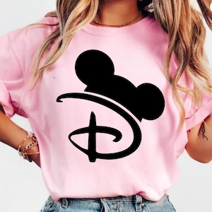 Pu&ograve; includere: T-shirt rosa chiaro con una silhouette nera di Mickey Mouse e il logo Disney. La maglietta ha maniche corte e girocollo. Il disegno &egrave; centrato sul davanti.