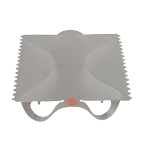 May include: A gray plastic cake decorating tool with a serrated edge and a handle with two loops. The tool has a red triangle logo.