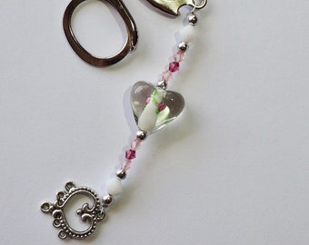 Small folding scissors with decorative fob, rose pink, green and white beads and a silver heart charm.