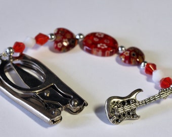 Small folding scissors with decorative beaded fob, red borealis beads and a silver guitar charm.