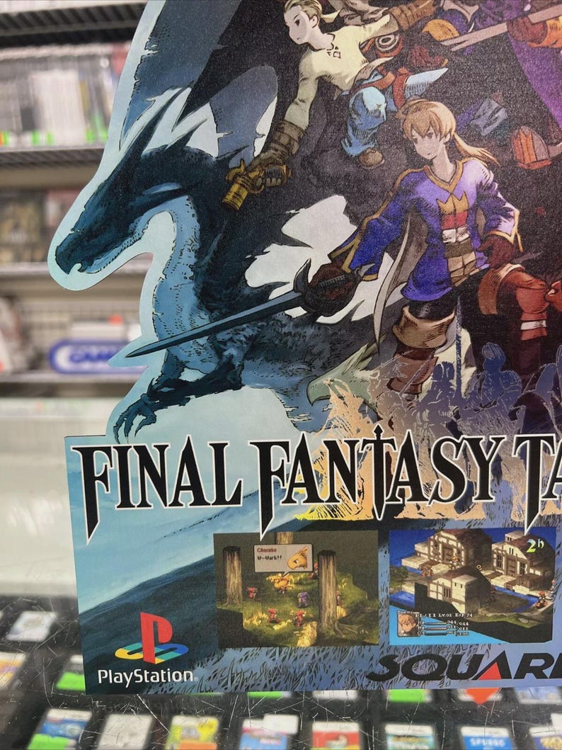May include: A promotional poster for Final Fantasy Tactics, featuring a blue dragon, characters with swords, and the PlayStation logo. The poster has the game's title and images of gameplay.