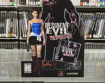 May include: A promotional display for the video game Resident Evil 3: Nemesis, featuring a cutout of a female character in a blue top and black skirt, and a large monster. The display includes the game's title and PlayStation logo, with a Mature rating.