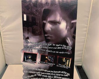 May include: A promotional poster for the video game "Silent Hill." The poster features the game's title in a glowing red font at the top. The image includes a grayscale portrait of a man and several smaller images from the game.