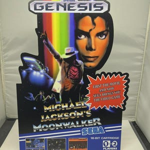 May include: A Sega Genesis video game cartridge for Michael Jackson's Moonwalker. The game's cover features a portrait of Michael Jackson, a rainbow, and a scene from the movie. The game is a 16-bit cartridge for 1 or 2 players.