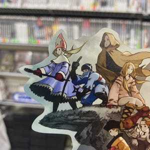 May include: A colorful illustration featuring several characters in fantasy attire. The characters are depicted in various poses, with one holding a weapon. The artwork has a detailed, cartoonish style, with a blurred background of shelves.