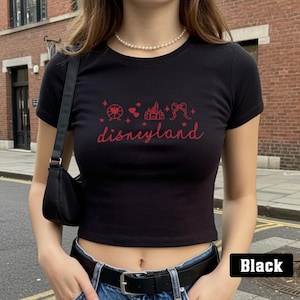 May include: Black cropped t-shirt with a red graphic of Disneyland icons and the text "disneyland".