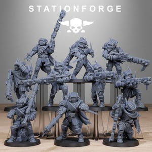 May include: A collection of gray miniature figurines of futuristic soldiers, each armed with weapons and armor. The figurines are arranged on black platforms, with the text "STATIONFORGE" and a skull logo visible at the top.