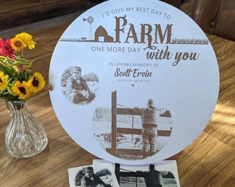May include: A white round sign with the text "I'd give my best day to FARM one more day with you" in brown lettering. The sign also includes a small barn illustration and two black and white photos of a man in a field.
