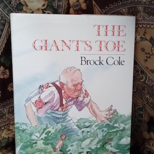 May include: A book cover with the title "THE GIANT'S TOE" by Brock Cole. The cover art depicts a large, elderly man in a floral shirt and suspenders reaching into a green, watery environment. A small figure is also in the water.