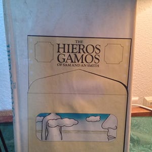 May include: A vintage book titled "The Hieros Gamos of Sam and An Smith" by Josephine Saxton. The cover features a stylized illustration of a figure and clouds. The book is a Doubleday Science Fiction edition.