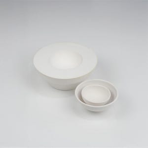 May include: Three white ceramic bowls, one large bowl with a wide rim and two smaller bowls nested inside.