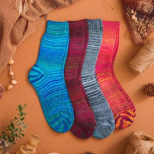 May include: Four pairs of colorful striped socks in blue, red, gray, and orange. The socks are made of a soft, knitted fabric.