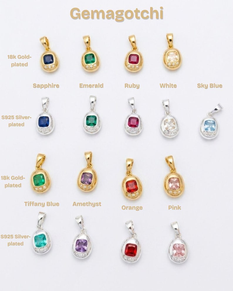 May include: A collection of Gemagotchi pendants arranged in rows, featuring 18k gold-plated and S925 silver-plated settings. Each oval pendant contains a square-cut gemstone in various colors including sapphire, emerald, ruby, white, sky blue, tiffany blue, amethyst, orange, and pink, accented with three small clear stones at the base.