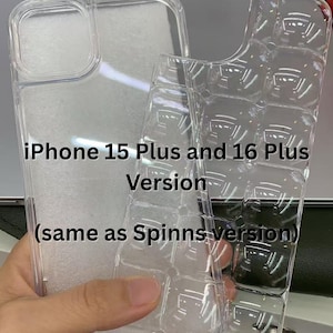 May include: Clear, transparent phone cases for iPhone 15 Plus and 16 Plus versions. The cases are made of a flexible material and have a protective design. The text on the image reads "iPhone 15 Plus and 16 Plus Version (same as Spinns version)".