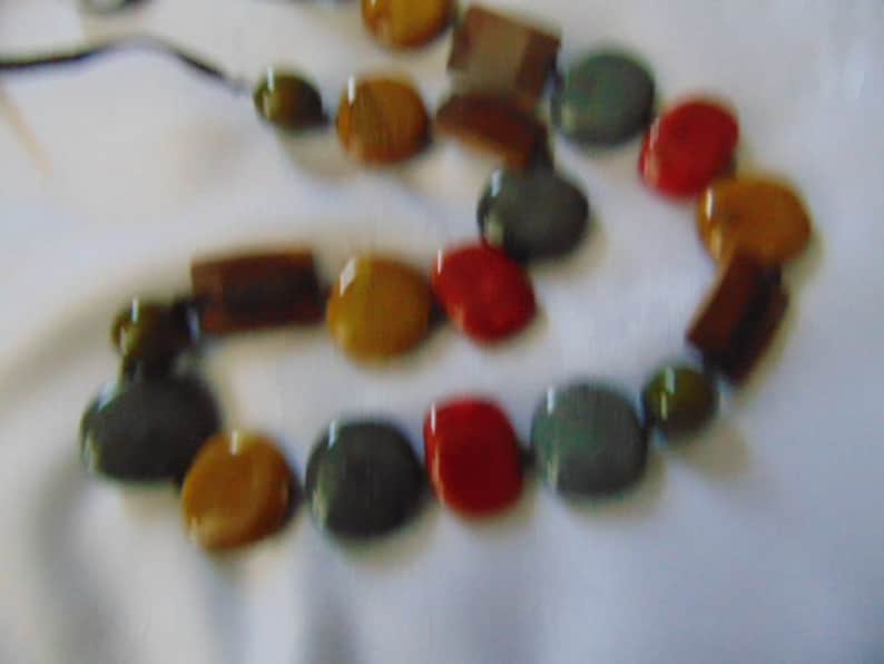 lovely long heavy multi coloured polished stone necklace on a dark brown ribbon 36 inches long