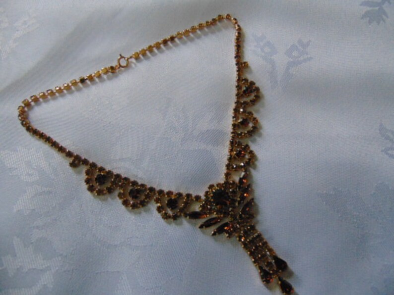 stunning deep amber coloured rhinestone necklace 16 inches long plus the drop tassel