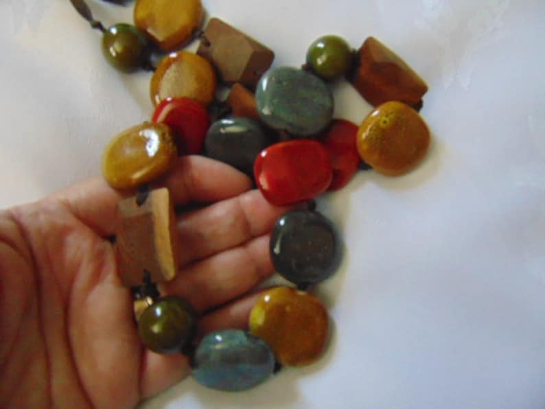 lovely long heavy multi coloured polished stone necklace on a dark brown ribbon 36 inches long