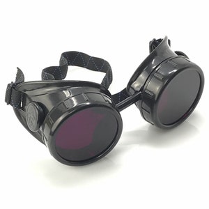 May include: Black steampunk-style goggles with round, dark lenses and a black adjustable strap.