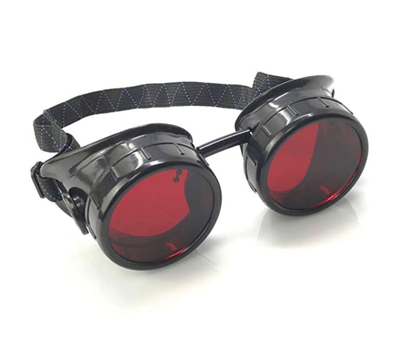 May include: Black steampunk-style goggles with red lenses and a black adjustable strap.