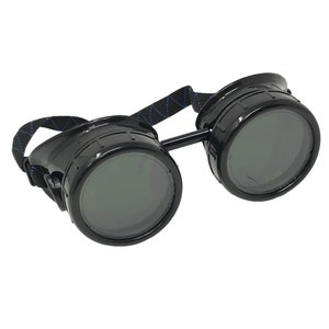 May include: Black steampunk-style goggles with round, dark lenses and a black adjustable strap.