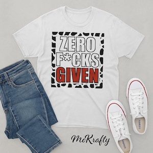 May include: White t-shirt with the text "ZERO F*CKS GIVEN" in a black and red design. The shirt is paired with blue jeans and white sneakers with red trim. The overall theme is casual wear.