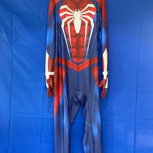 May include: A red and blue spandex Spider-Man costume with a white spider logo on the chest. The costume has a zipper in the back and is designed to look like the Spider-Man suit from the video game.
