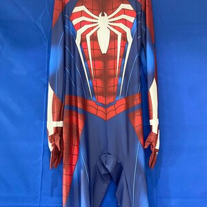 May include: A blue and red spandex Spider-Man costume with a white spider logo on the chest. The costume has a zipper in the back and a hood.