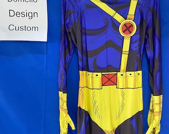 May include: A blue and yellow full-body costume with a red X on the chest and a yellow belt. The costume has a black and blue pattern on the chest and legs. The costume is on a hanger.