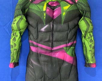 May include: A black, green, and pink full-body costume with a muscular design. The costume has a zipper in the front and a high neck.
