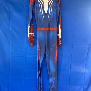 May include: A blue and red Spiderman costume with a white spider logo on the back.