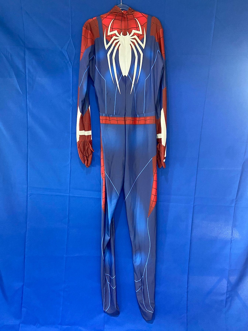 May include: A blue and red Spiderman costume with a white spider logo on the back.