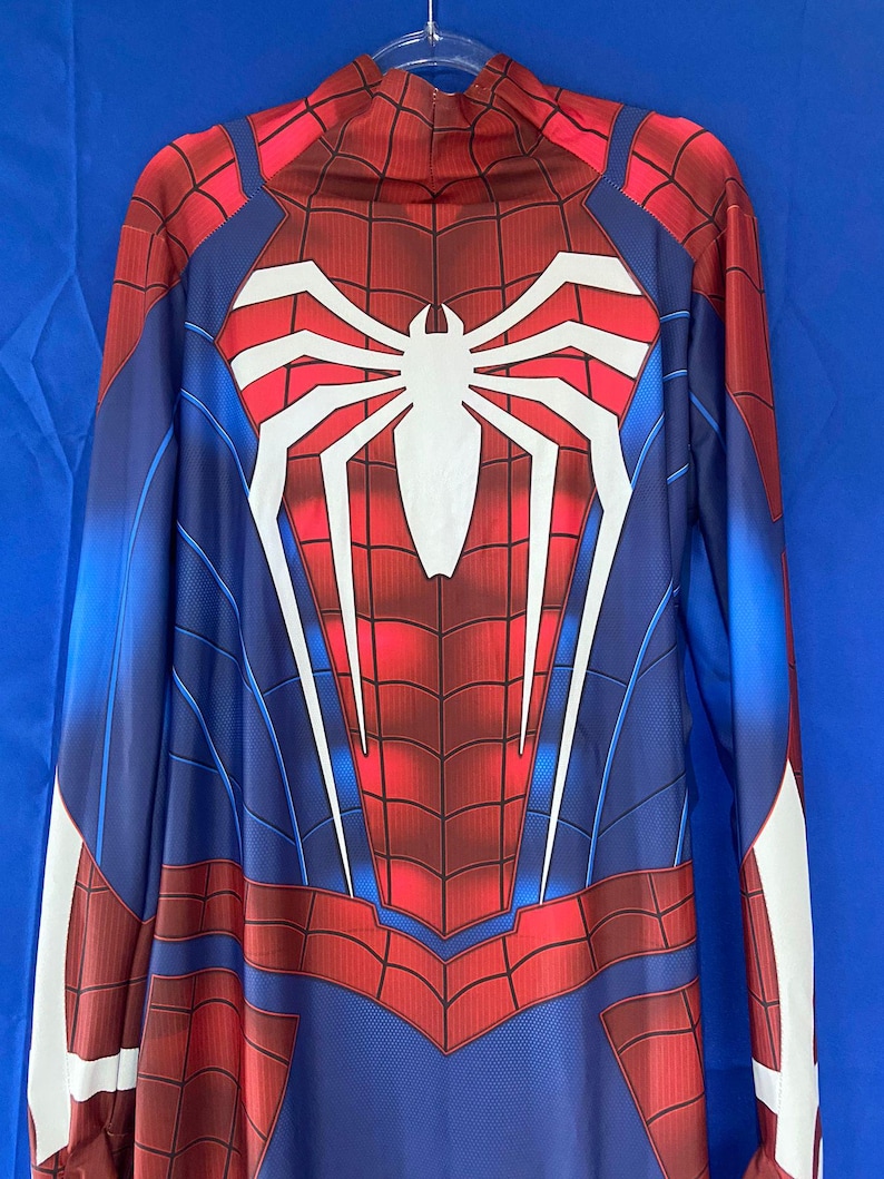 May include: A red and blue Spiderman costume with a white spider logo on the chest. The costume has a zipper in the back and long sleeves.