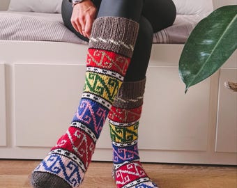 May include: Colorful knitted knee-high socks with geometric patterns in shades of red, blue, green, yellow, and brown.