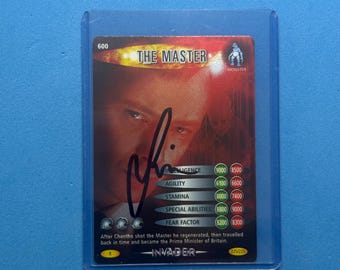 May include: A trading card of "The Master" with a signature, in a protective sleeve. The card has a monster graphic and includes statistics for intelligence, agility, stamina, special abilities, and fear factor. The card is in a protective sleeve.