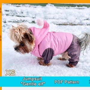 May include: A small dog wearing a pink jumpsuit with a hood and a pom-pom, standing in the snow. The jumpsuit has dark purple sleeves and pants. Text on the image reads "XS" and "Jumpsuit Gentle elf PDF Pattern."