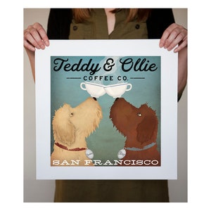May include: A vintage-style illustration of two dogs, Teddy and Ollie, with coffee cups in their mouths. The text reads "Teddy & Ollie Coffee Co." and "San Francisco".