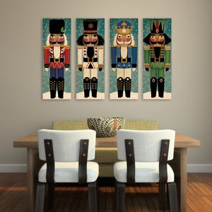May include: Four colorful nutcracker figurines with different hats and outfits, displayed on a wall above a wooden table with two chairs.