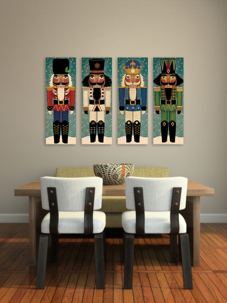 May include: Four colorful nutcracker figurines with different hats and outfits, displayed on a wall above a wooden table with two chairs.